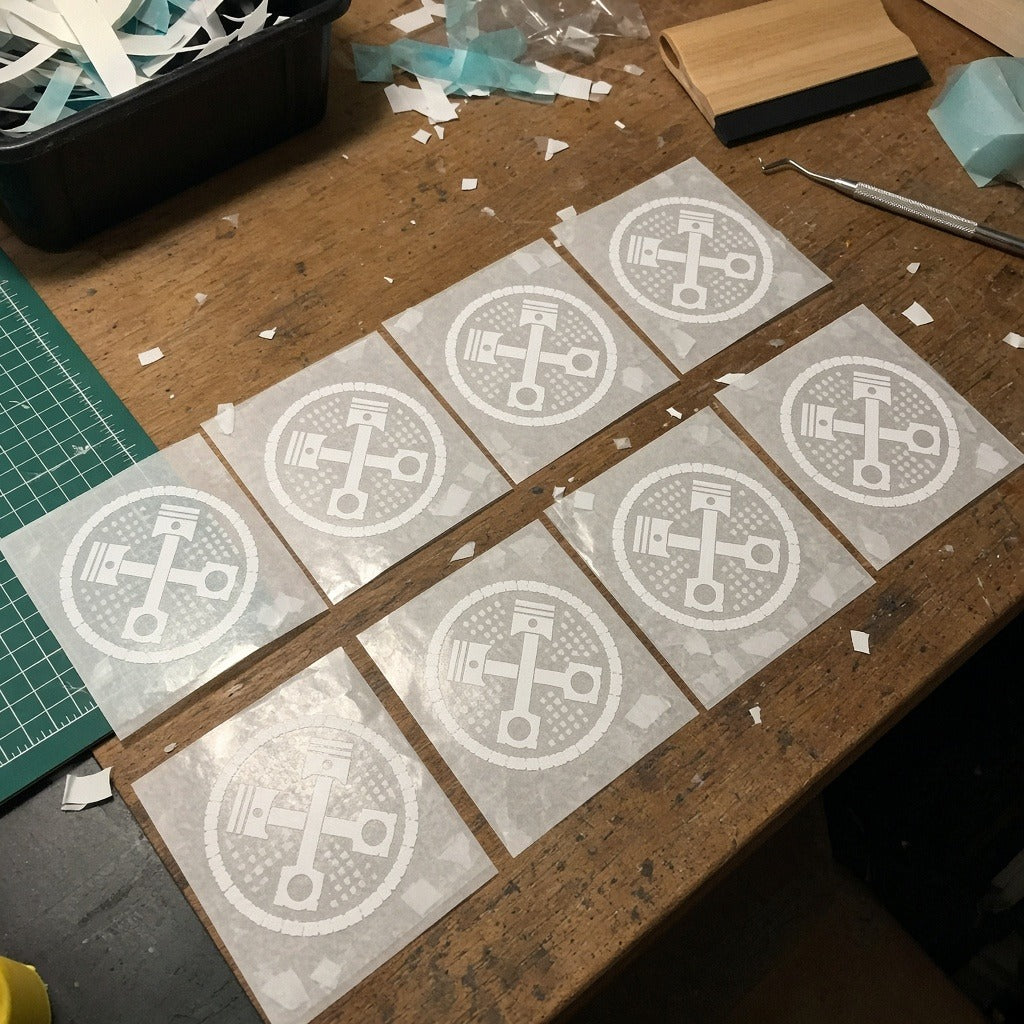Custom car club crew decal pack, weeded vinyl on transfer tape on a workbench