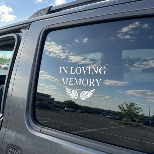 White In Loving Memory vinyl decal with wings installed on an SUV rear window