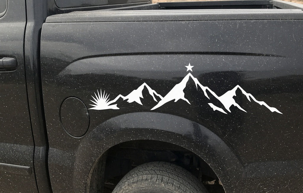 Desert mountain and star vinyl side graphic on the bed side of a black pickup truck